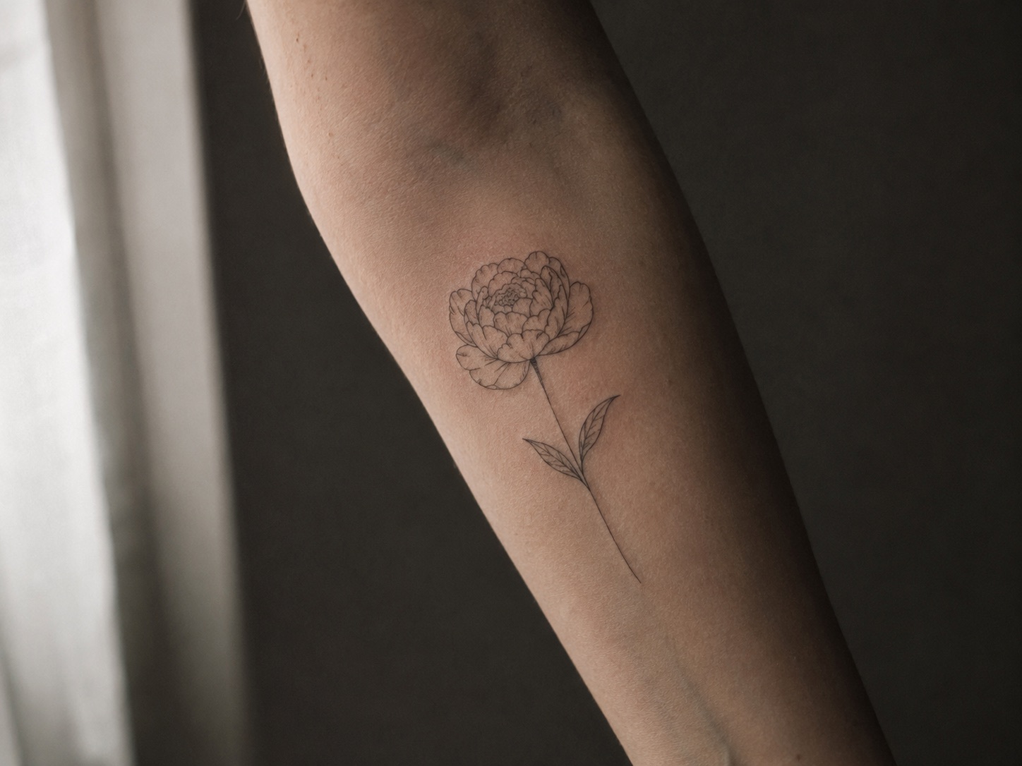 Fine-line floral tattoo